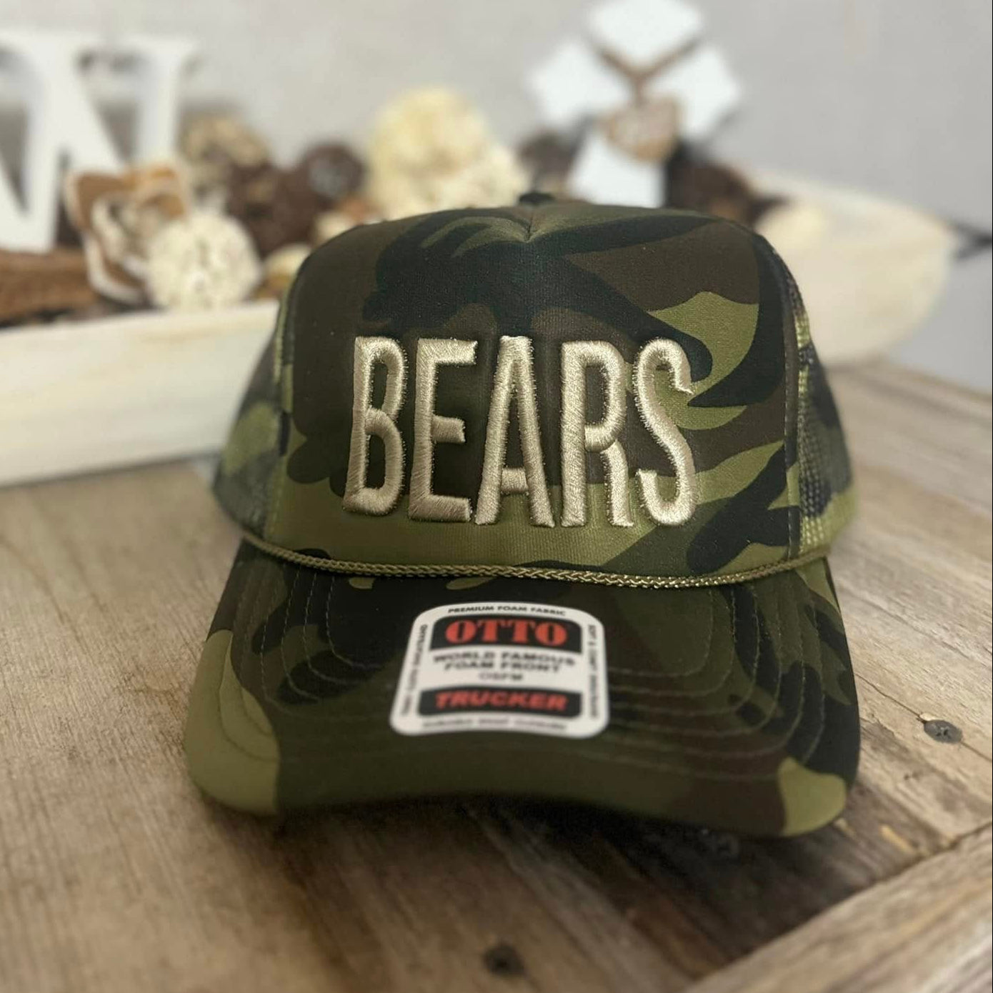 Camouflage cap with 'BEARS' embroidery on a wooden surface