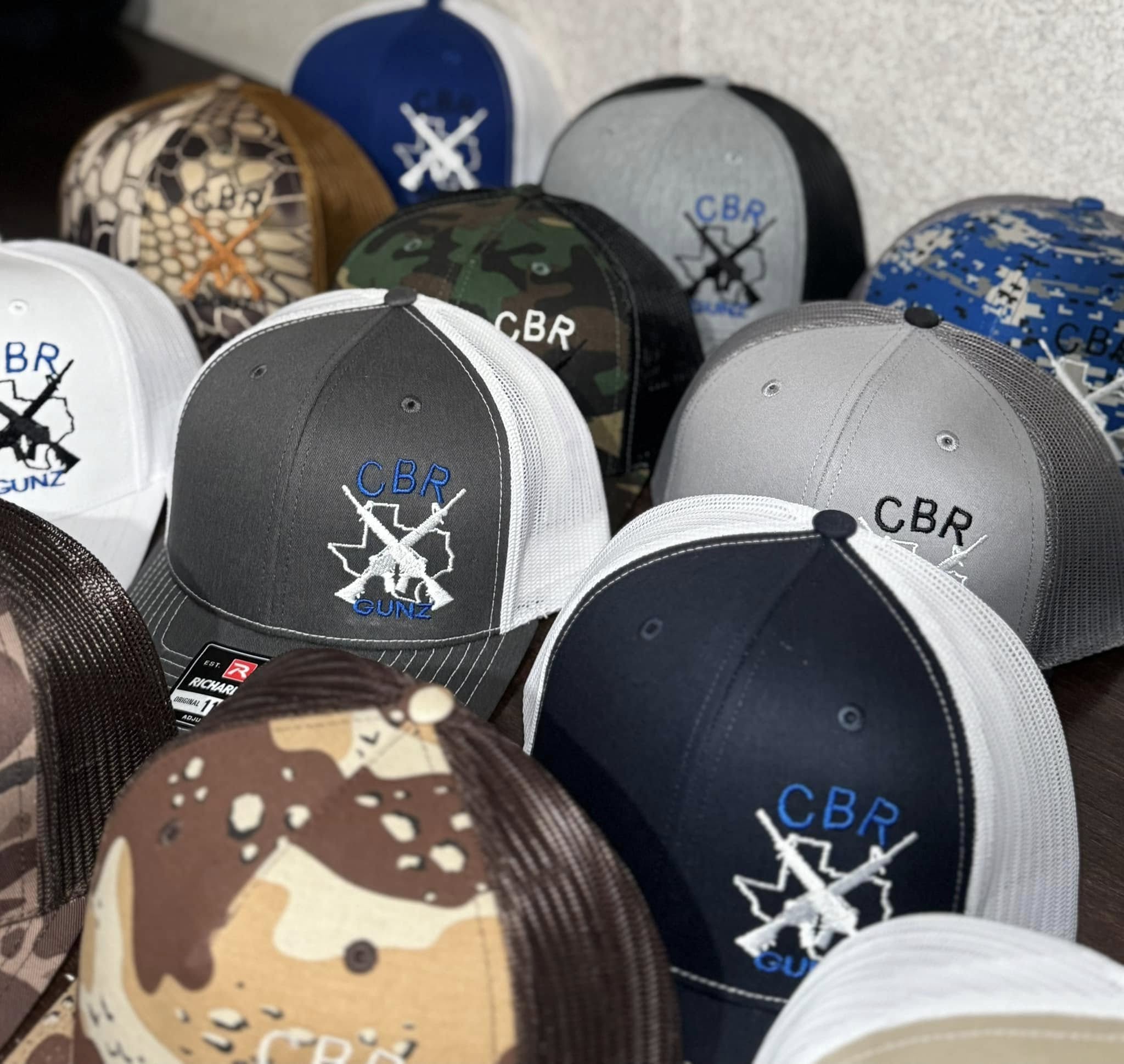 Group of hats with CBR Logo embroidered on them