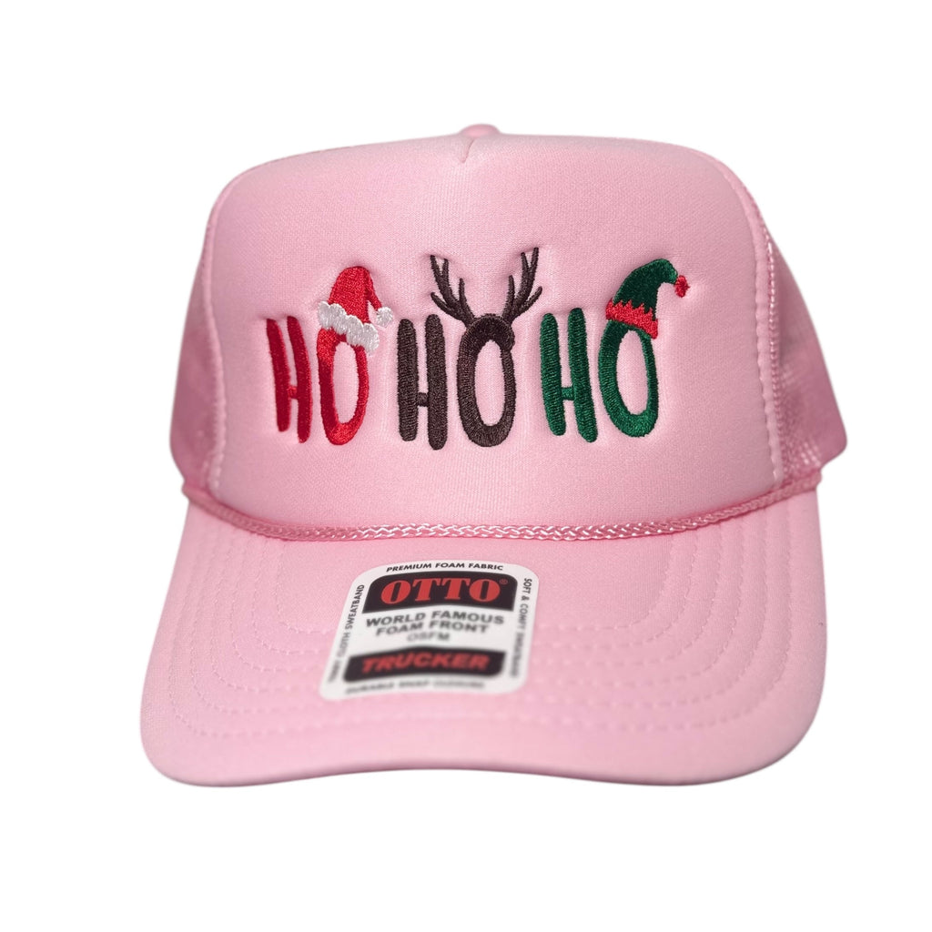 Pink cap with 'HO HO HO' text and Christmas-themed design on a white background